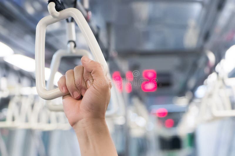 People Hand Holding Handle on the Train during Rush Hour.Handle Loop in
