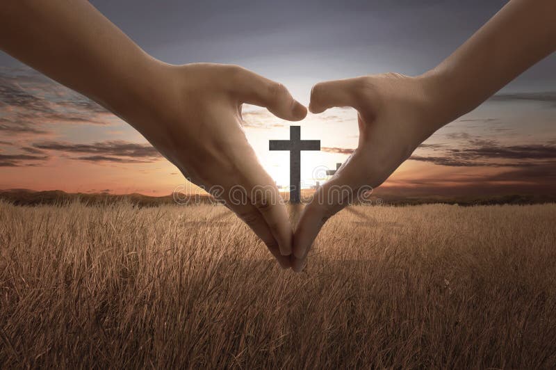 People hand making heart sign with bright cross inside royalty free stock image