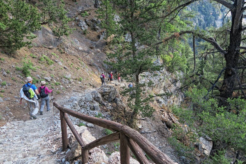 People hiking on trail through Samaria gorge. Crete, Greece.