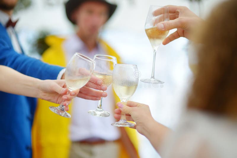 People holding wine glasses at festive event