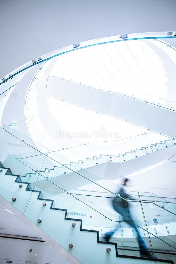 People inside a modern building walking up the stairs