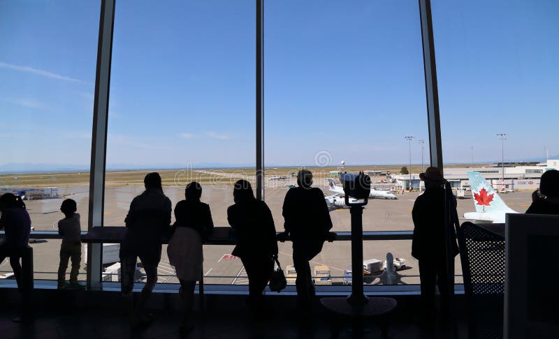 People inside YVR airport watching air canada airplane stock photo People inside YVR airport watching air canada airplane stock photo
