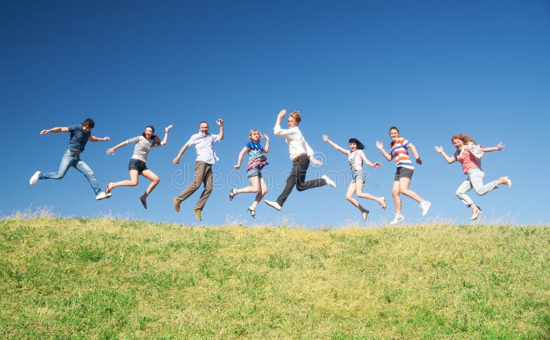 People jump on hill across sky