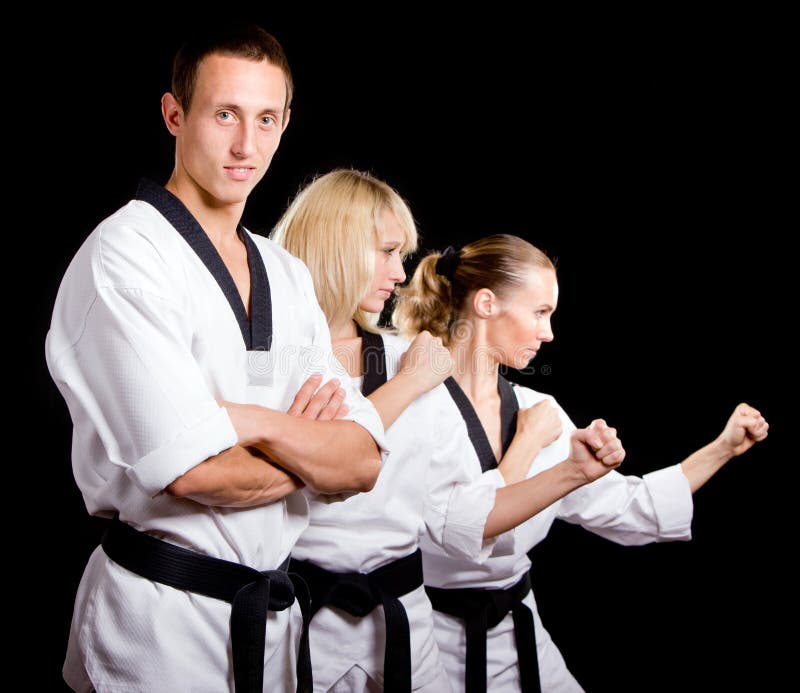 People in kimono make martial arts exercise