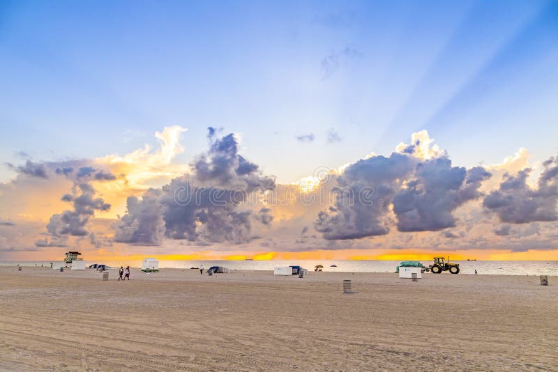 People In Late Afternoon Walk Along South Beach And Enjoy The Sunset