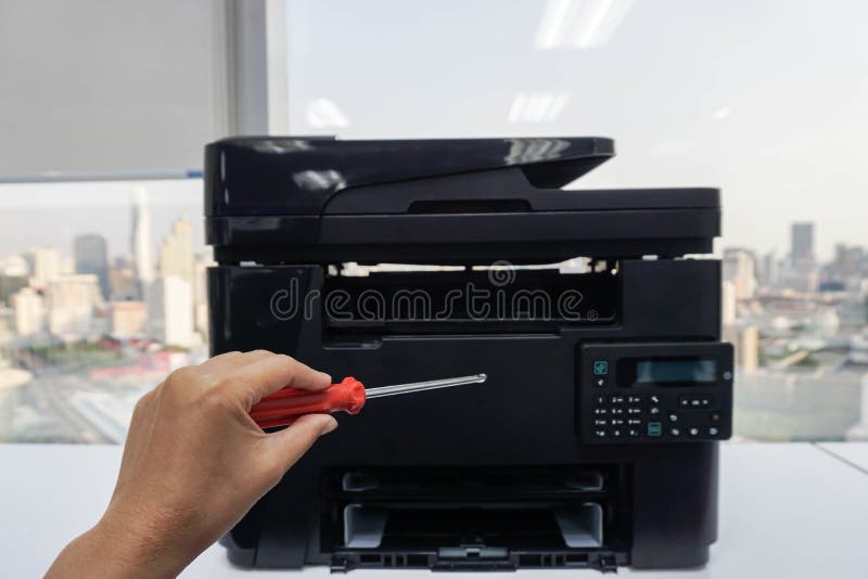 People left hand hold red screwdrivers for repair and maintenance printer stock photo