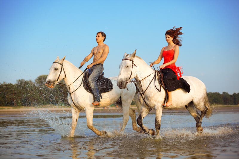 People in love at sunset in the sea