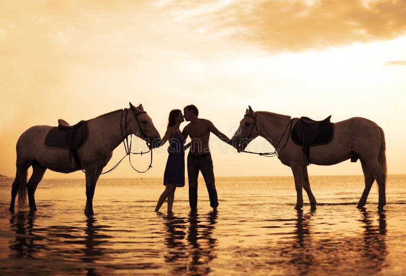 People in love at sunset in the sea