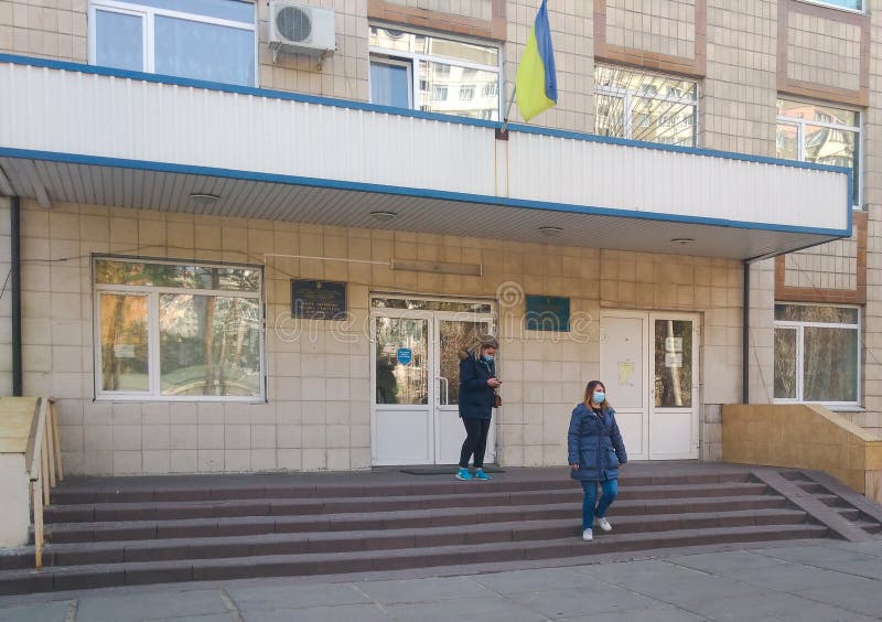 People in medical masks leave the state medical institution in Ukraine stock images People in medical masks leave the state medical institution in Ukraine stock images