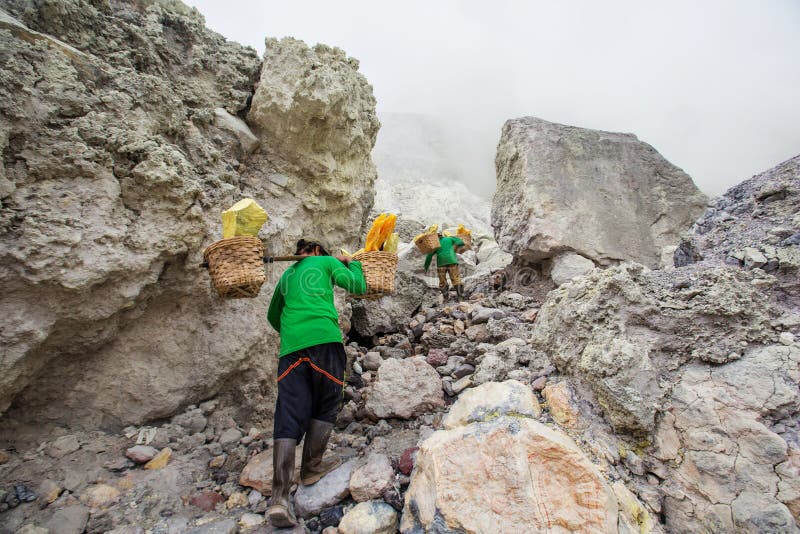People mining sulphur in Ijen volcano, Java , Indonesia royalty free stock photography