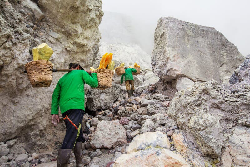 People mining sulphur in Ijen volcano, Java , Indonesia stock photography