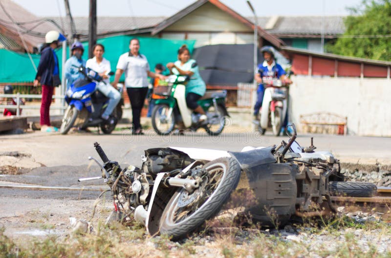 People stand watch demolished the damaged motorcycle accident which caused the train crash. People stand watch demolished the damaged motorcycle accident which caused the train crash.