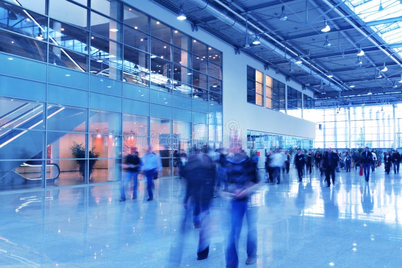 People moving in glass corridor