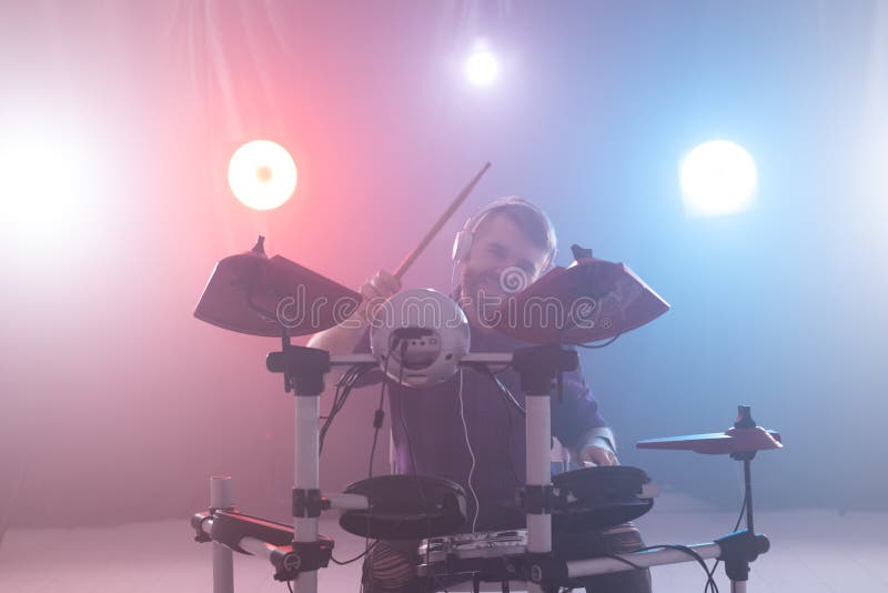People, music and hobby concept - man plays with drumsticks on drums on the stage stock photos People, music and hobby concept - man plays with drumsticks on drums on the stage stock photos
