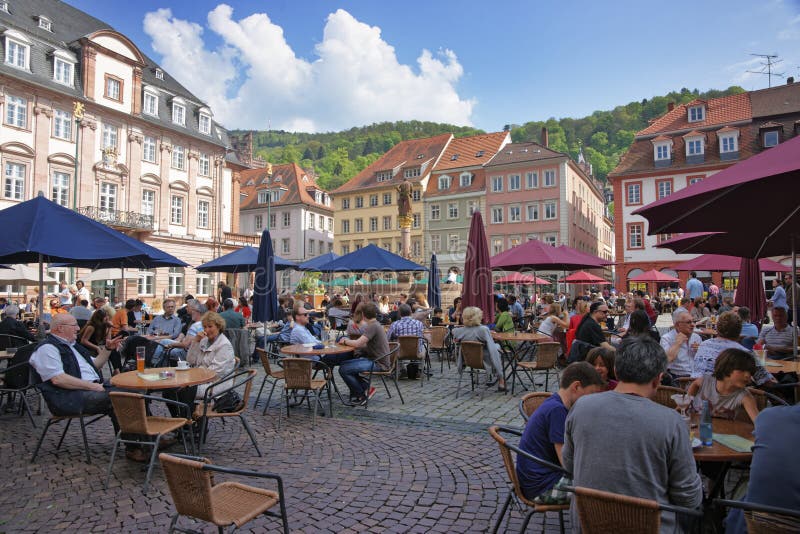People in outdoor cafe on central square in Heidelberg