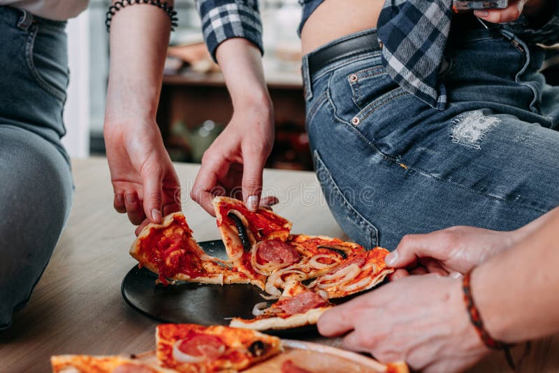 Group Of Friends Eating Pizza Together At Home Stock Photo, Picture and  Royalty Free Image. Image 56950664.