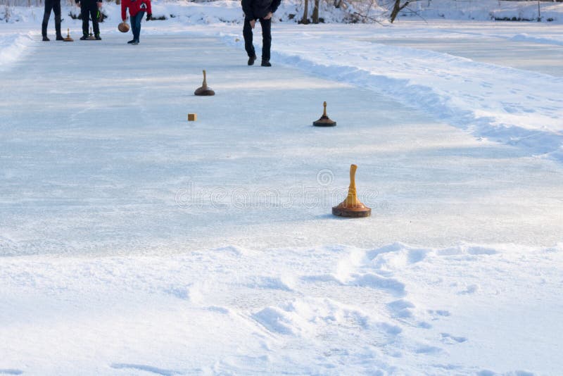 People playing curling on a frozen lake, Austria, Europe