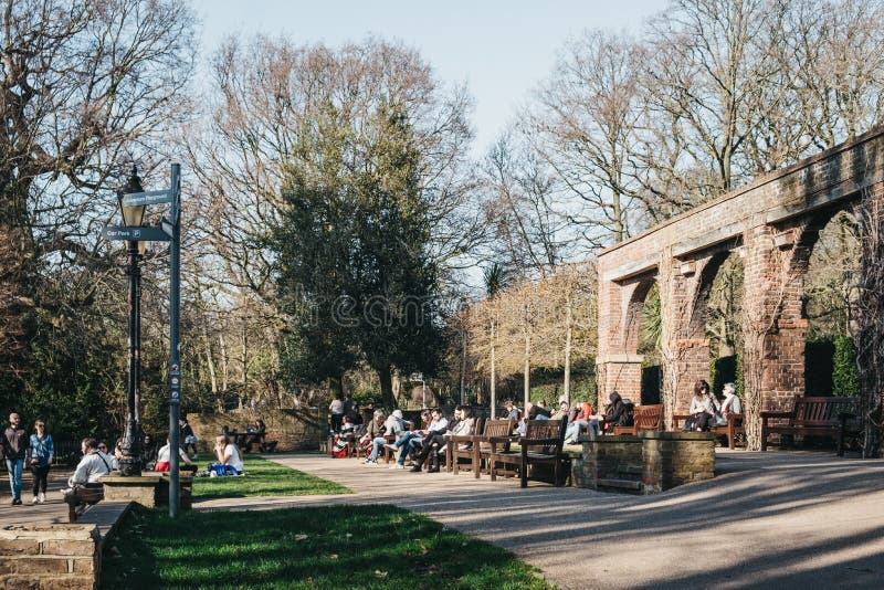 People relaxing inside Holland Park, London, UK