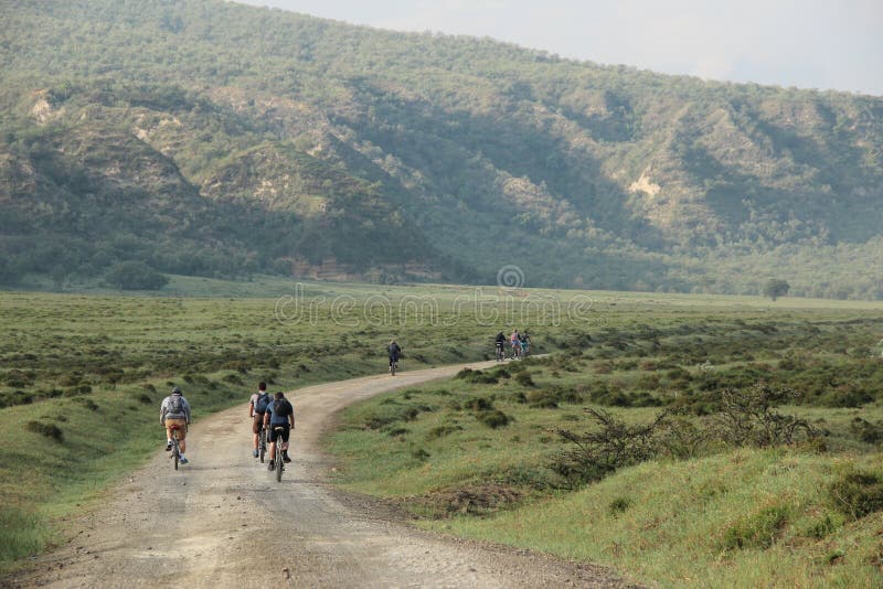 Cyclists ride bikes through Hell&x27;s Gate National Park in Kenya