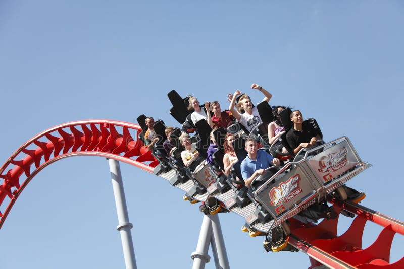 People riding roller coaster stock photo