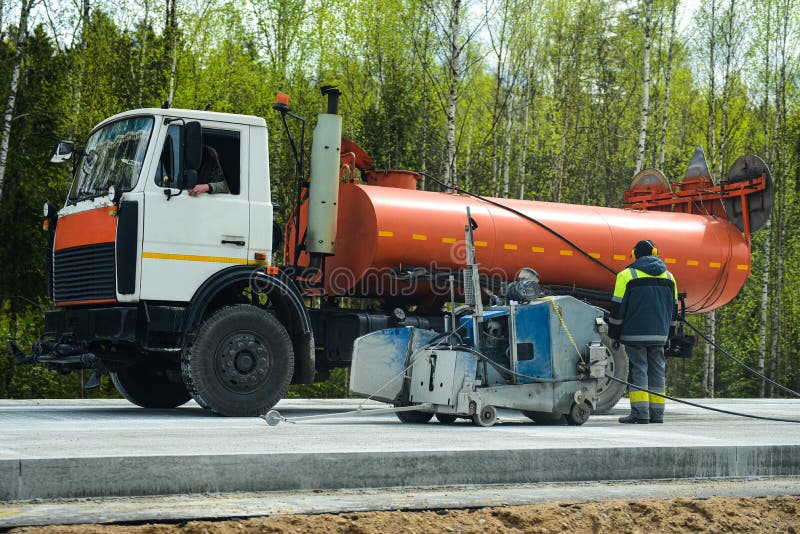 People on Road Equipment Build a Concrete Road Pavement Stock Image