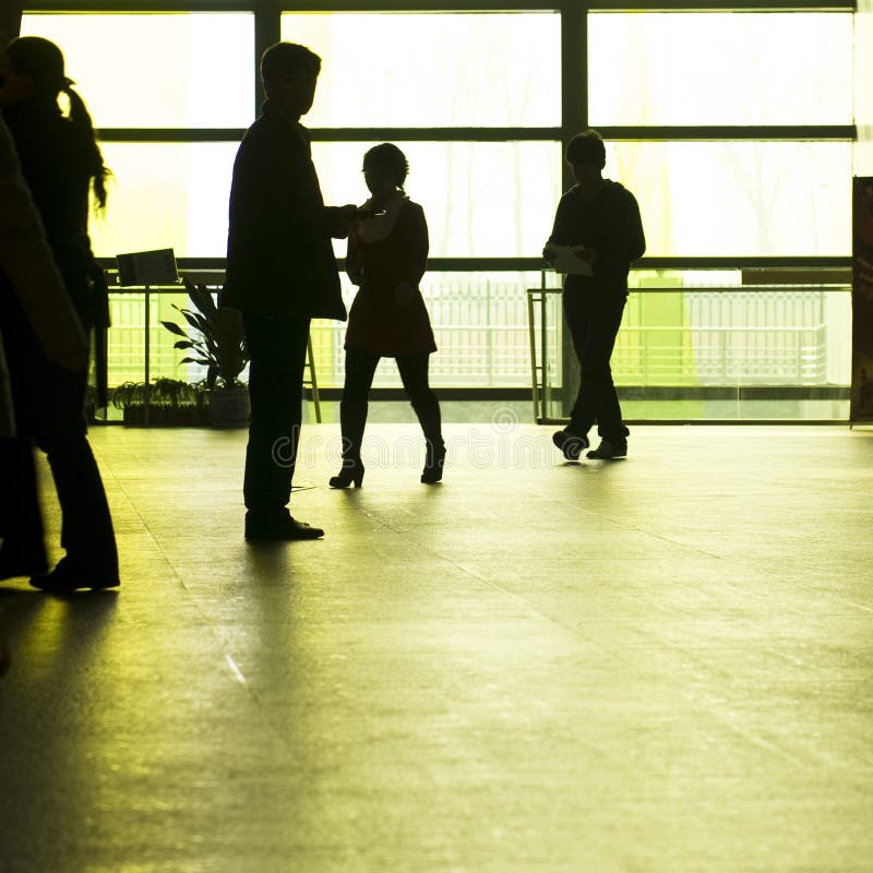 People silhouettes at office building