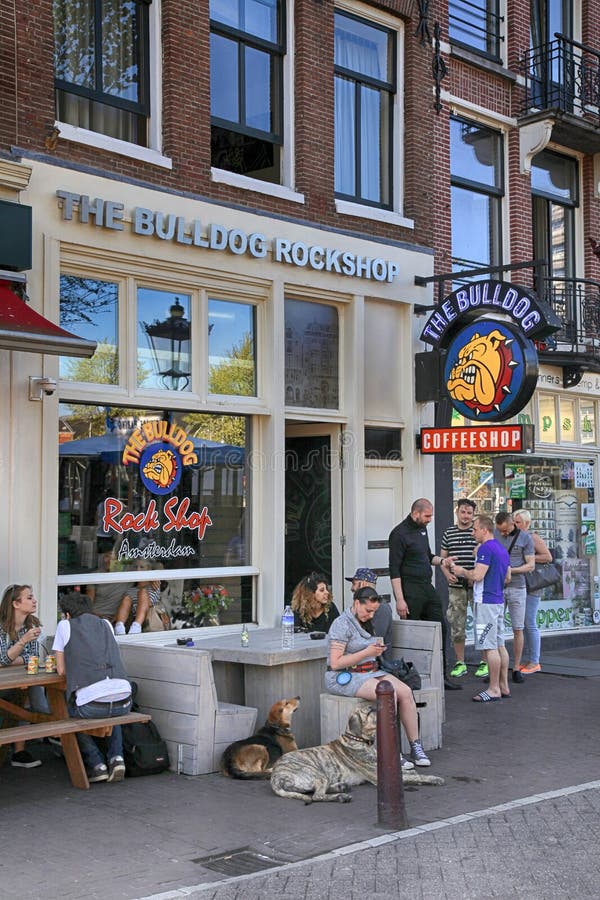 People sitting at Bulldog coffeeshop on the street in Amsterdam