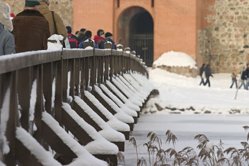 People on snow covered bridge