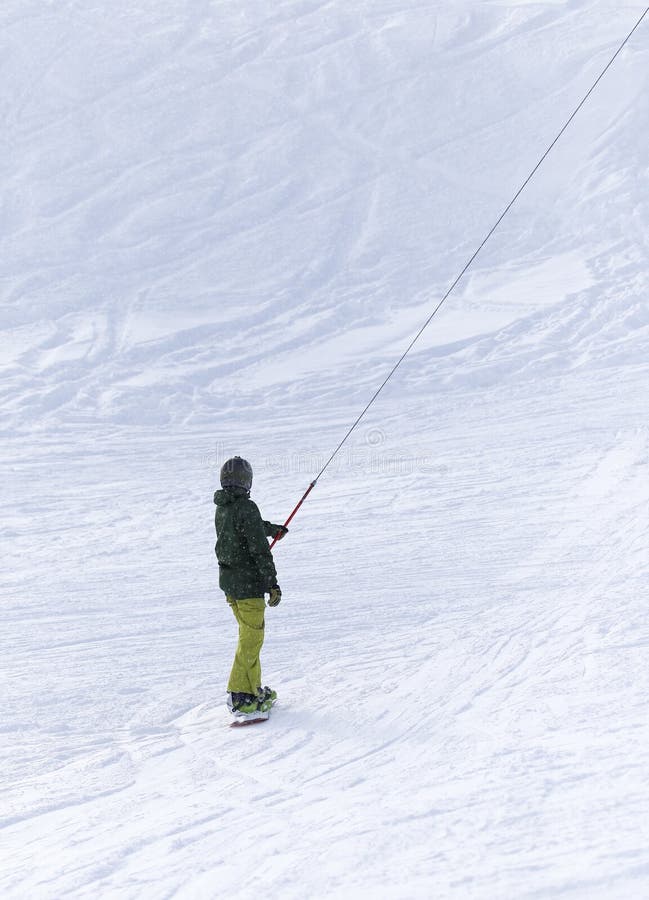 People snowboarding on the snow in the winter