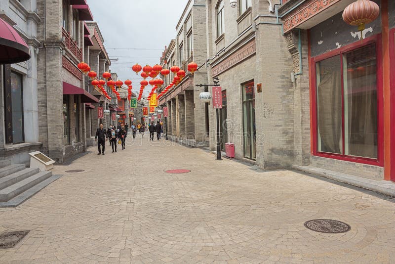 People strolling trough a hutong near Dashilan St. royalty free stock photo People strolling trough a hutong near Dashilan St. royalty free stock photo