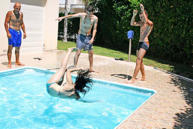 Man throwing women to swimming pool. Man throwing women to swimming pool.