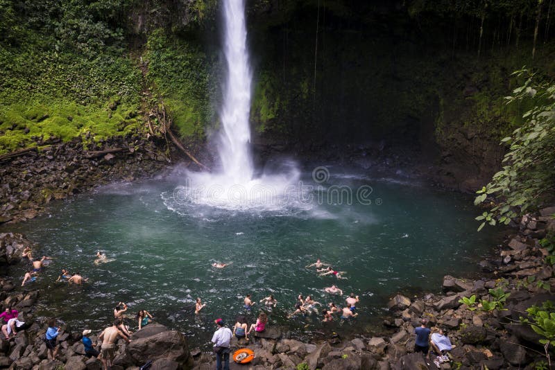 People swimming at the pool of the La Fortuna Waterfall in Costa Rica.