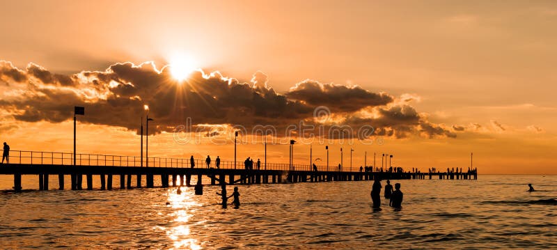 People swimming at sunset