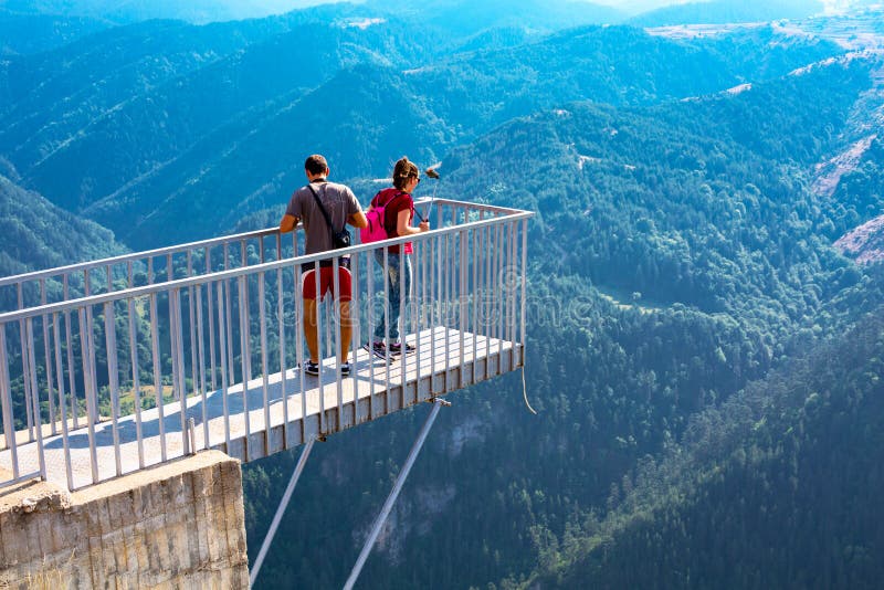 People taking photo at panoramic mountain viewpoint Eagle eye, Orlovo Oko in Rhodope stock photos People taking photo at panoramic mountain viewpoint Eagle eye, Orlovo Oko in Rhodope stock photos