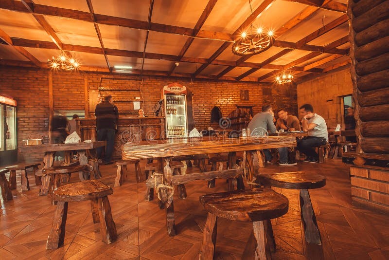 People Talking Inside Traditional Cafe with Wooden Furniture Editorial
