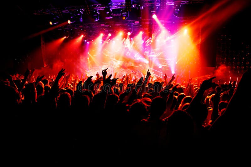 People with their hands up at a concert of their favorite group royalty free stock photo People with their hands up at a concert of their favorite group royalty free stock photo