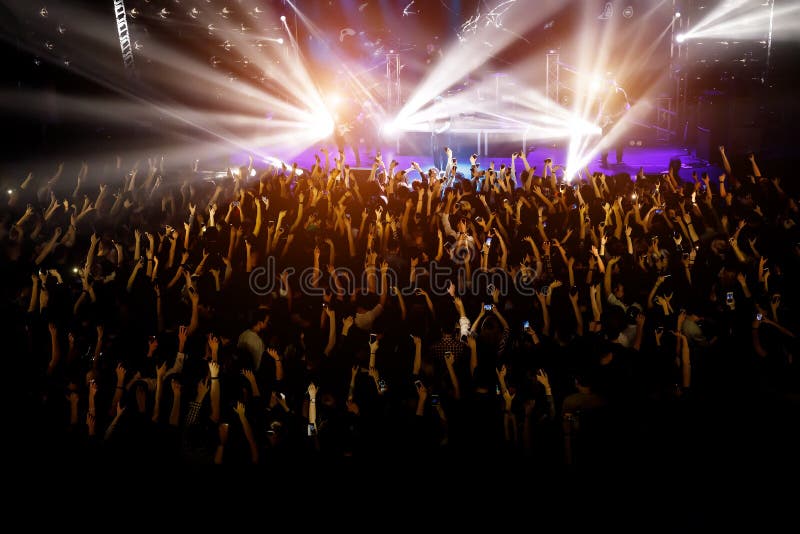 People with their hands up at a concert of their favorite group stock images People with their hands up at a concert of their favorite group stock images