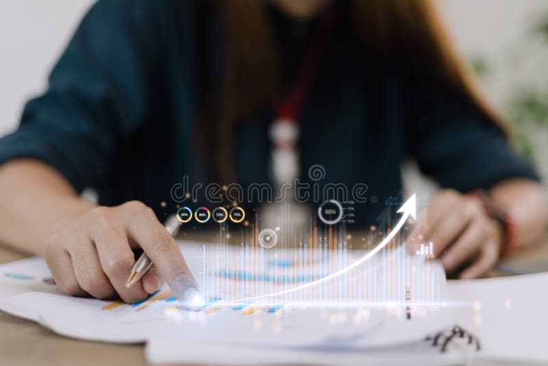 People using tablets And using his finger to touch the screen With a business graph showing up in a virtual screen. New startup stock photos