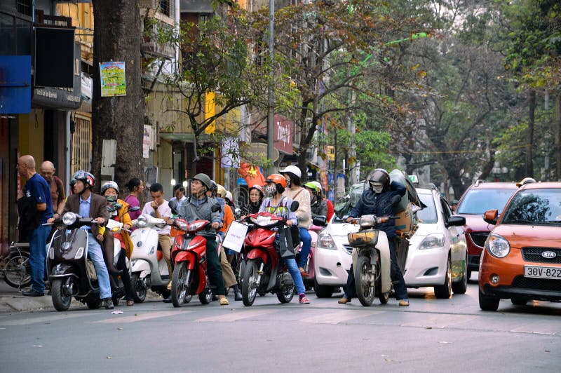 Hanoi, Vietnam, February 6, 2014: People waiting in traffic lights in Hanoi, Vietnam.