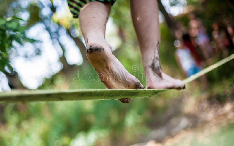 People Walk on a Tightrope Slackline Stock Photo Image of back, male