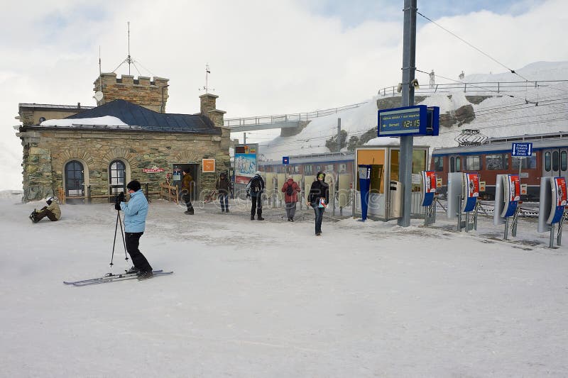 People walk at the upper Gornergratbahn railway station in Zermatt, Switzerland.