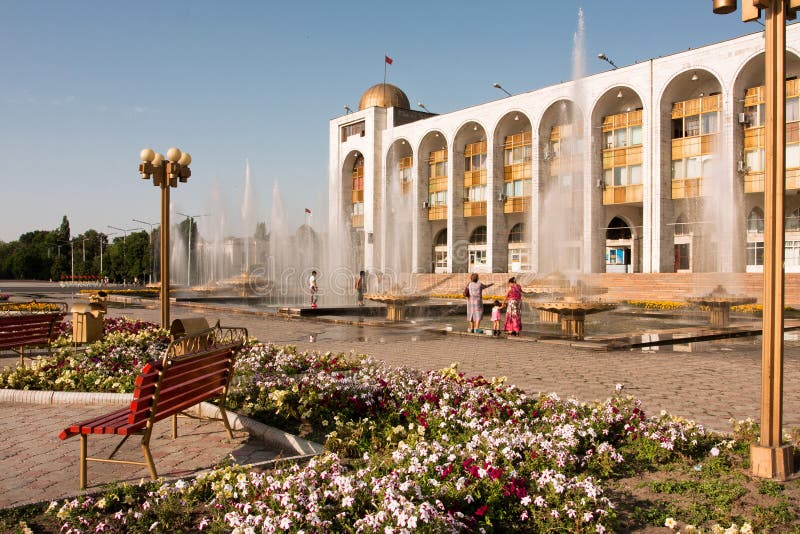 People walking around fountains at main square