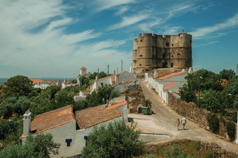 People walking up a street at the Castle of Evoramonte