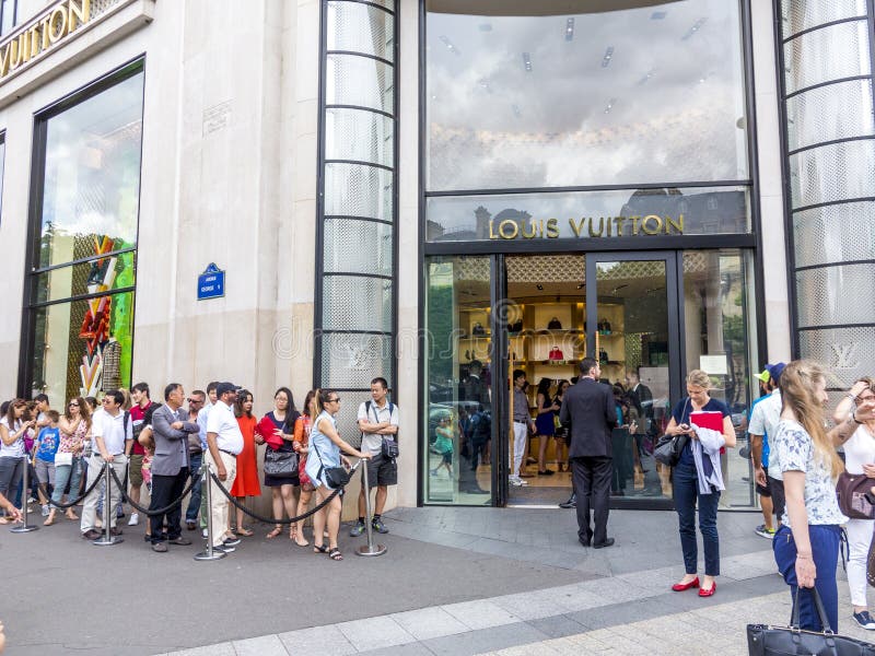 Queue of shoppers outside Louis Vuitton store on Champs Elysees in