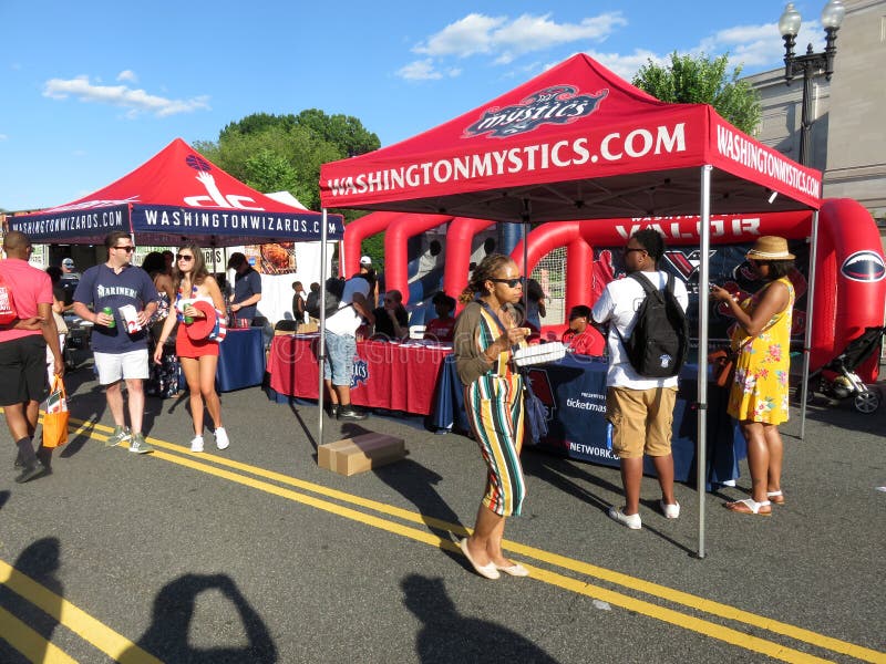 People by the Washington Mystics Tent and Washington Wizards Tent