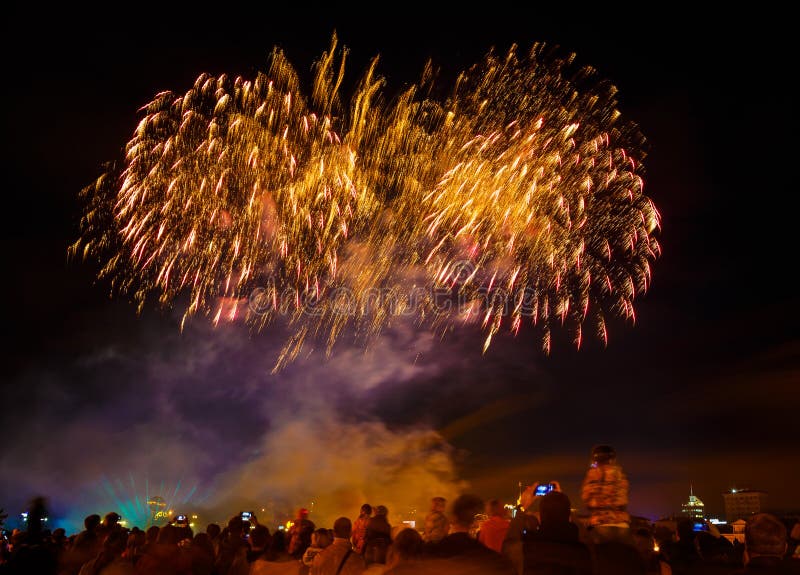 People watch and shoot phones bright fireworks over city on New Year stock photos People watch and shoot phones bright fireworks over city on New Year stock photos