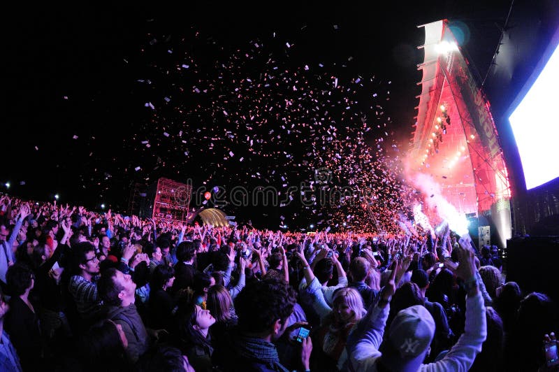 People watching a concert, while throwing confetti from the stage at Heineken Primavera Sound 2013 Festival