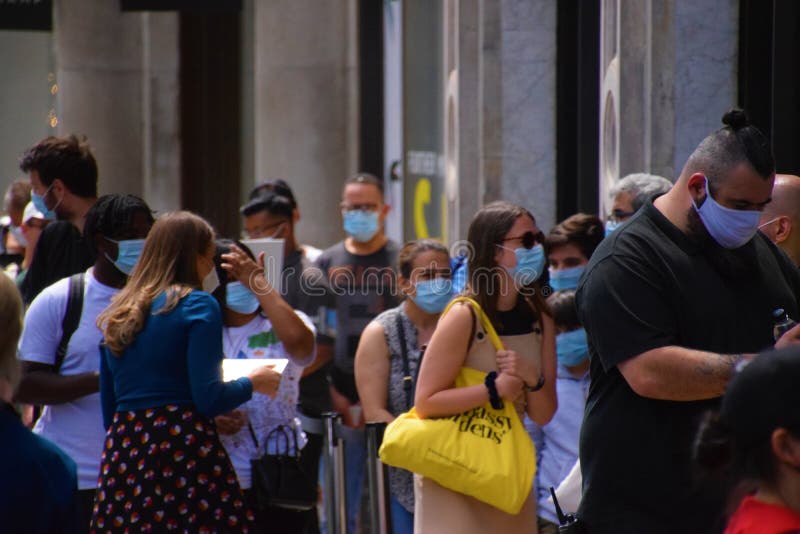 People wearing face masks outside a shop in Central London
