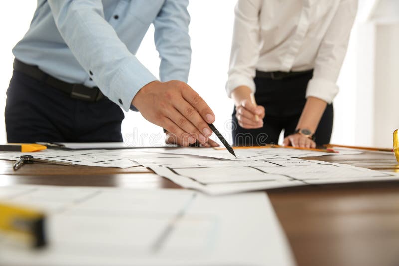 People working with construction drawings at table, closeup royalty free stock photos