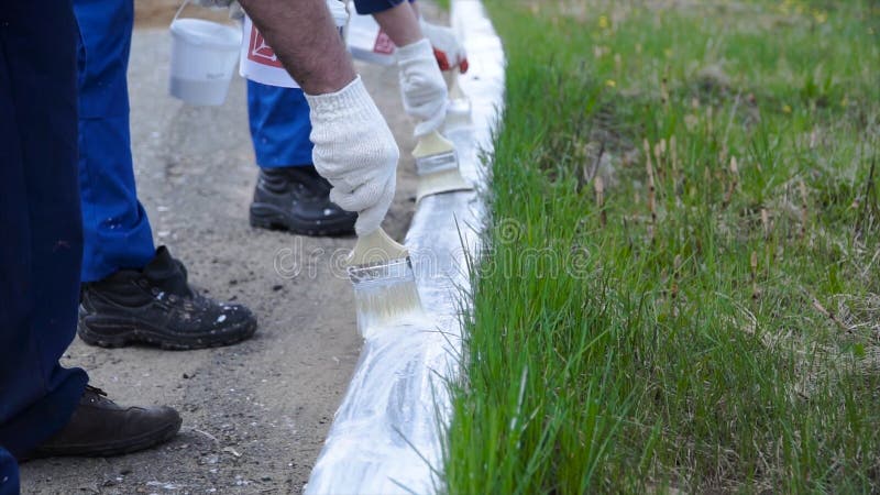 People working with Hand wearing white gloves and painting with a paint brush on borders. Clip. Workers in form painted stock photography People working with Hand wearing white gloves and painting with a paint brush on borders. Clip. Workers in form painted stock photography